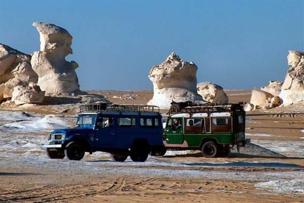 4x4 jeeps among white chalk rocks in the White Desert