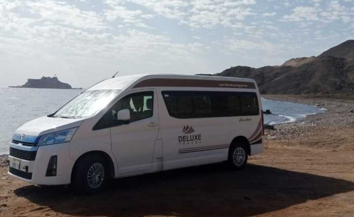 Deluxe Travel Egypt private van parked by the Red Sea for a Hurghada airport transfer