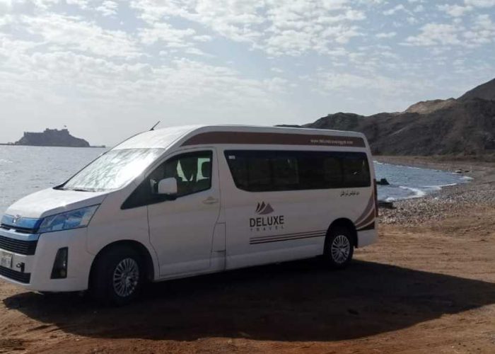 Deluxe Travel Egypt private van parked by the Red Sea for a Hurghada airport transfer