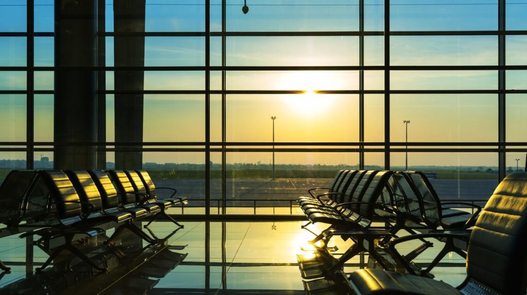 Airport departure lounge with a plane at the gate – airport transfer in Egypt