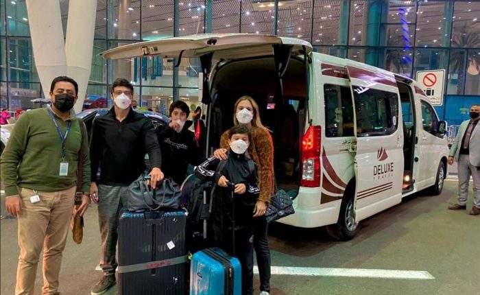 Guests with luggage and the Deluxe Travel Egypt van at Cairo Airport