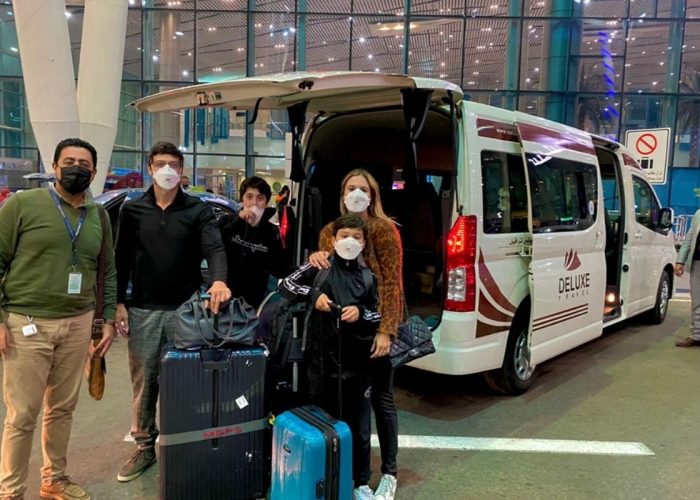 Guests with luggage and the Deluxe Travel Egypt van at Cairo Airport
