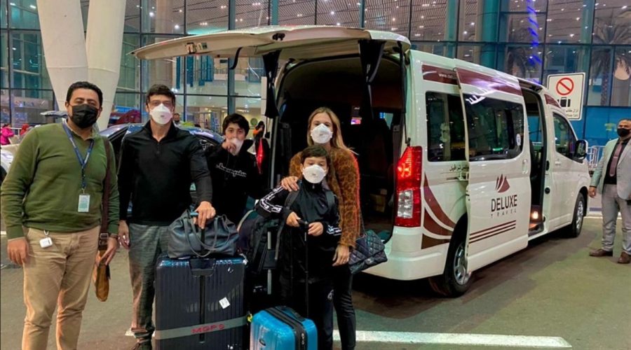 Guests with luggage and the Deluxe Travel Egypt van at Cairo Airport