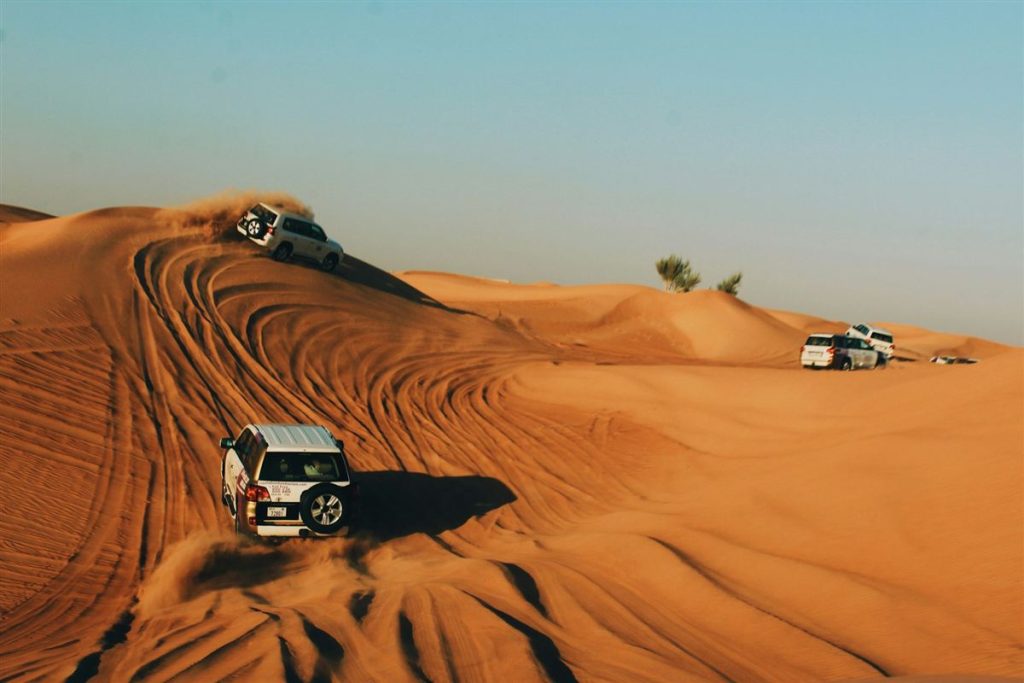 4x4 jeep crossing golden sand dunes in the Egyptian desert