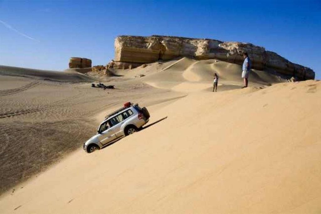 4x4 jeep driving down a sand dune near Bahariya Oasis