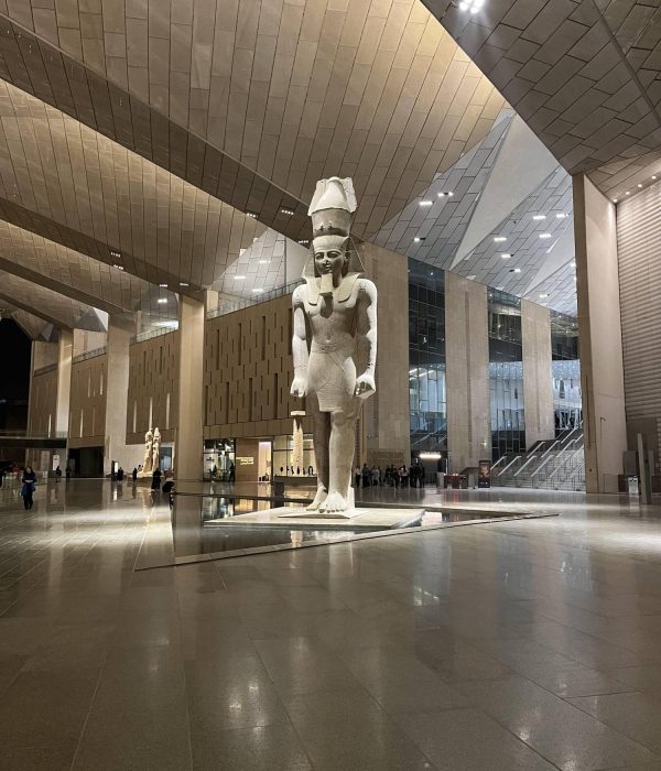 Colossal royal statues lining the Grand Staircase of the Grand Egyptian Museum in Giza