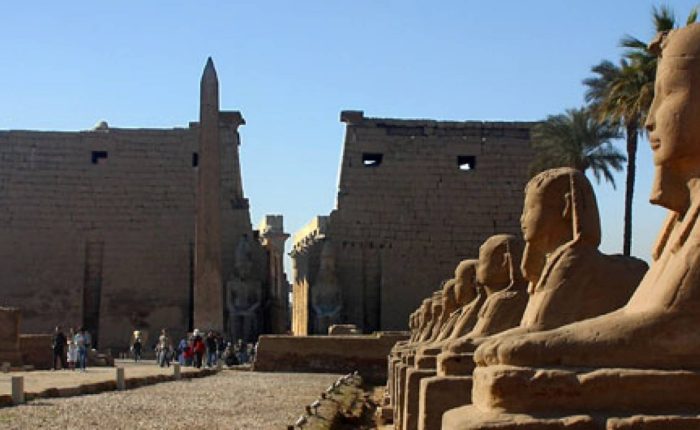 Entrance pylon and obelisk of Luxor Temple with the avenue of sphinxes