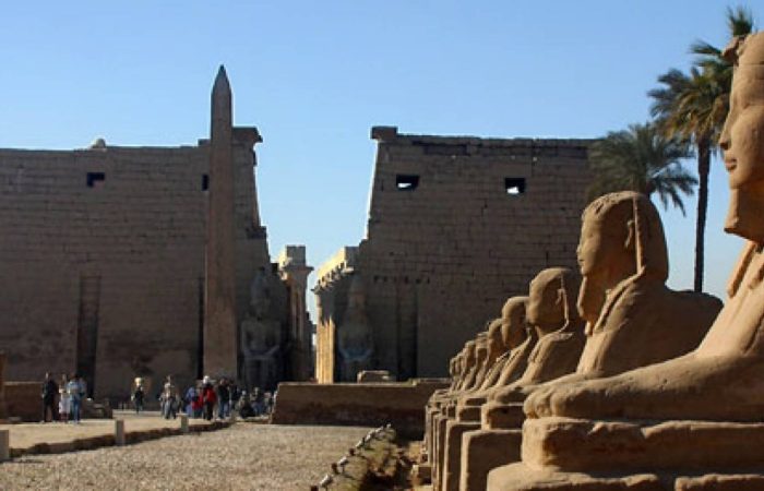 Entrance pylon and obelisk of Luxor Temple with the avenue of sphinxes