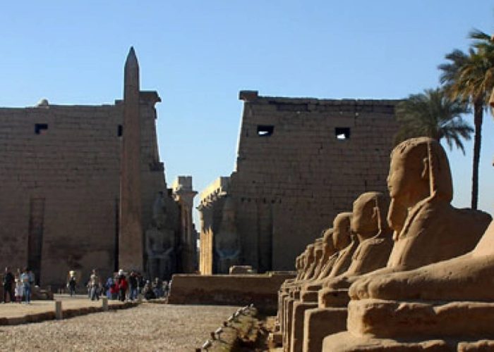 Entrance pylon and obelisk of Luxor Temple with the avenue of sphinxes