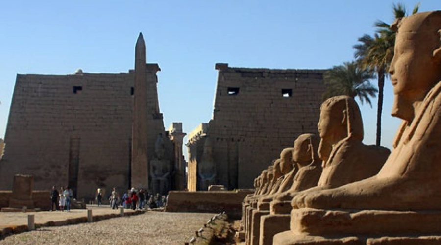 Entrance pylon and obelisk of Luxor Temple with the avenue of sphinxes
